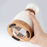 Wood Aromatherapy Desk Lamp Humidifier Aromatherapy Machine with a user holding the base and power cord.