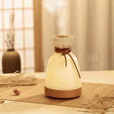 Wood Aromatherapy Desk Lamp Humidifier Aromatherapy Machine emitting mist in a serene setting with warm lighting.