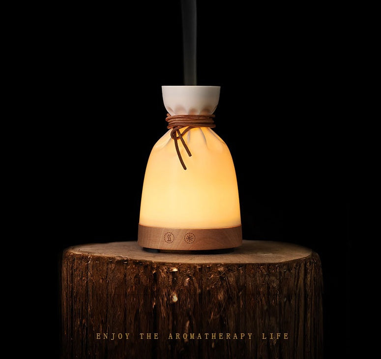 Wood Aromatherapy Desk Lamp Humidifier Aromatherapy Machine on a wooden surface with gentle smoke.